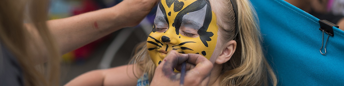 a young child gets their face painted