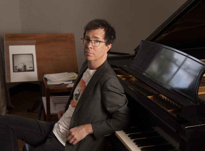 Ben Folds sitting at a piano.